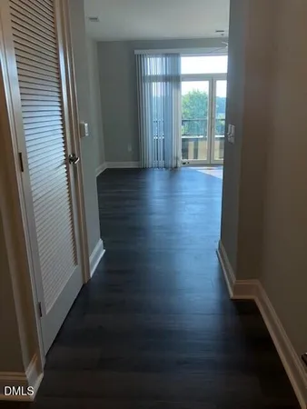 a view of wooden floor and windows in a room