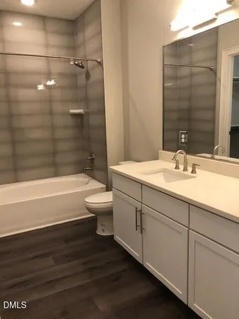 a bathroom with a sink a toilet and bathtub