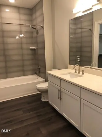 a bathroom with a sink a toilet and bathtub