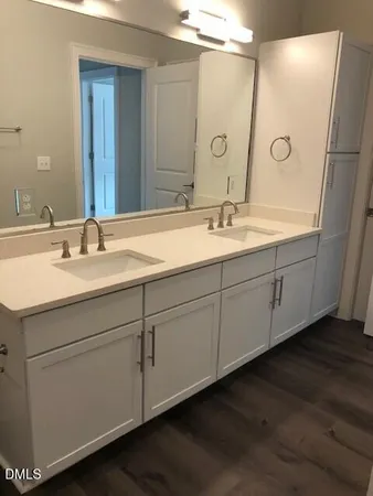a bathroom with a double vanity sink and mirror