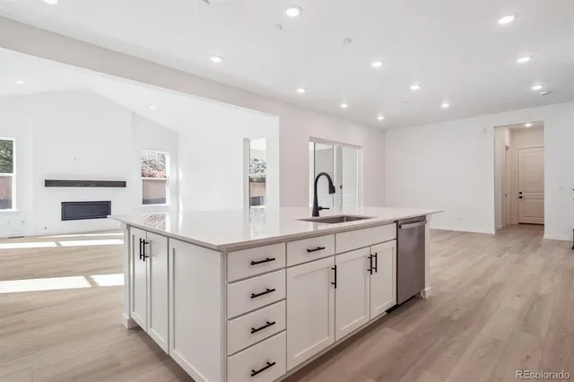 a kitchen with cabinets and wooden floor