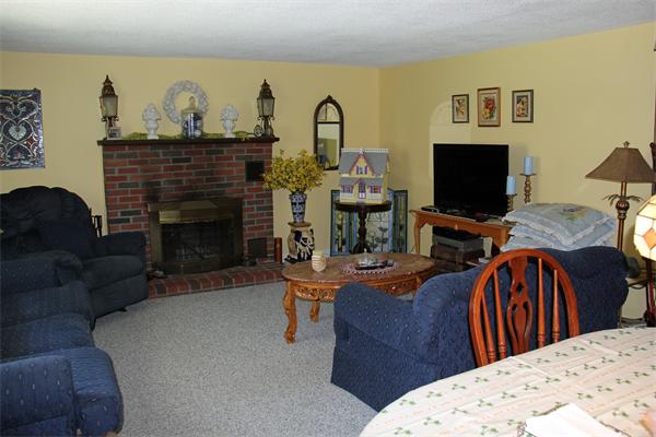8 Gary Road Chelmsford, MA 01824 - Photo 14 of 17 a living room with furniture a fireplace and a flat screen tv
