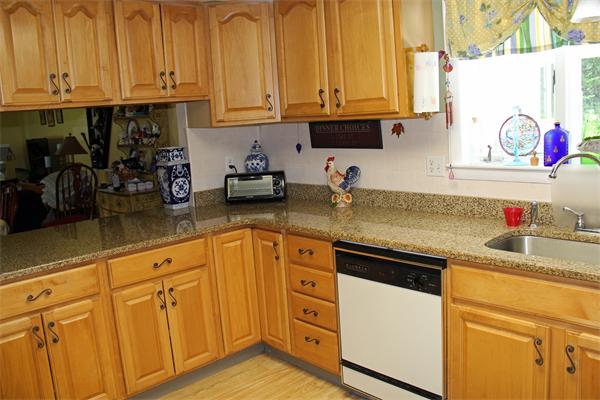 8 Gary Road Chelmsford, MA 01824 - Photo 4 of 17 a kitchen with stainless steel appliances granite countertop a sink a stove and cabinets