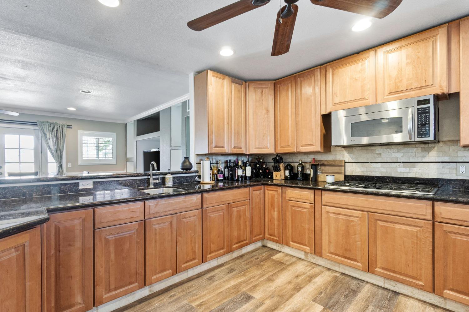 16972 Monreal Road Madera, CA 93636 - Photo 12 of 34 a large kitchen with granite countertop a large window
