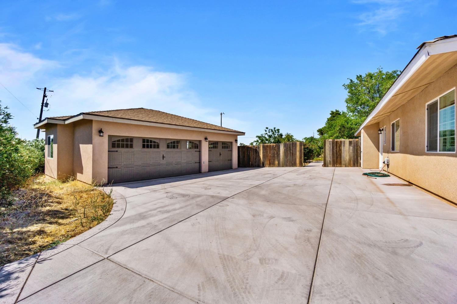 16972 Monreal Road Madera, CA 93636 - Photo 2 of 34 a front view of a house with a yard
