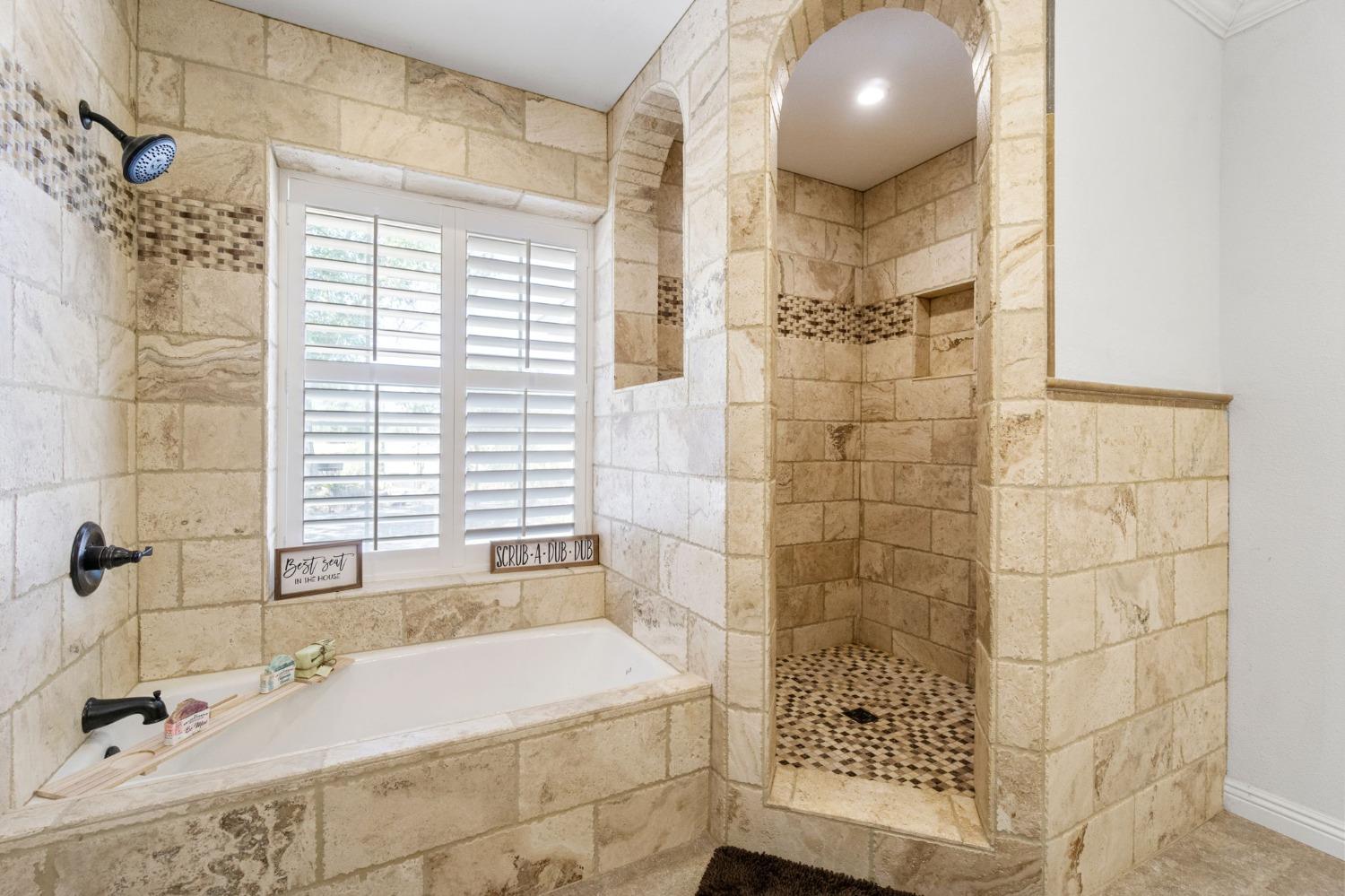 16972 Monreal Road Madera, CA 93636 - Photo 22 of 34 a bathroom with a bathtub and shower