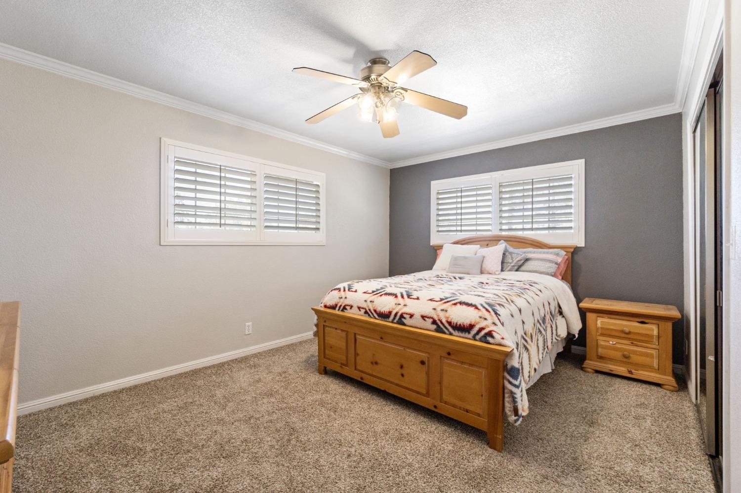 16972 Monreal Road Madera, CA 93636 - Photo 25 of 34 a bedroom with a bed and window