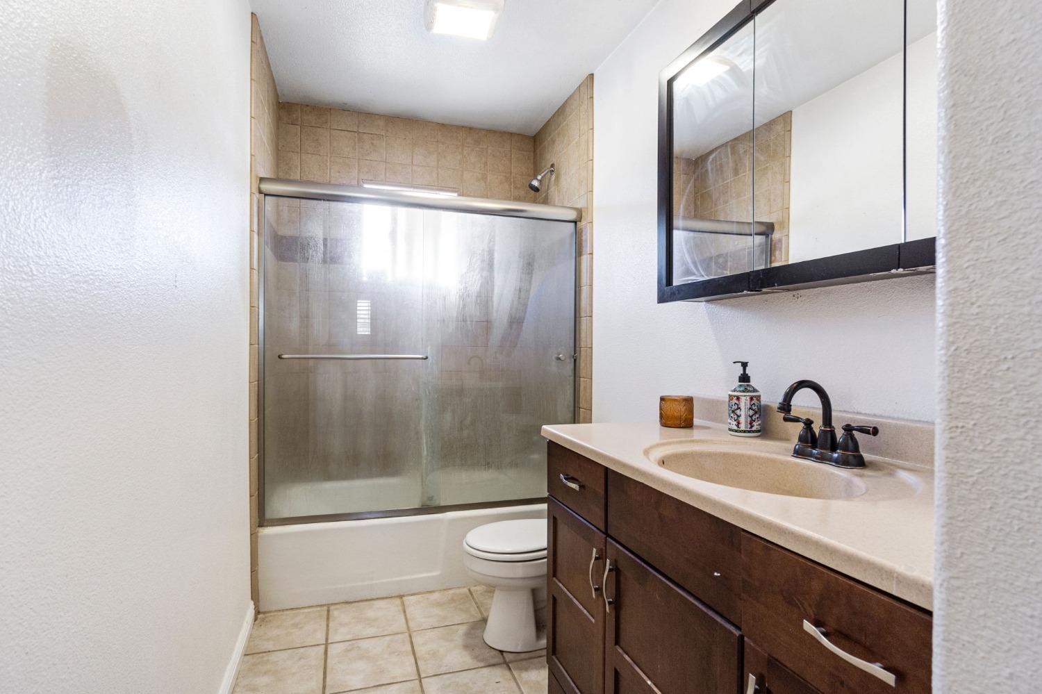 16972 Monreal Road Madera, CA 93636 - Photo 26 of 34 a bathroom with a sink a toilet and shower