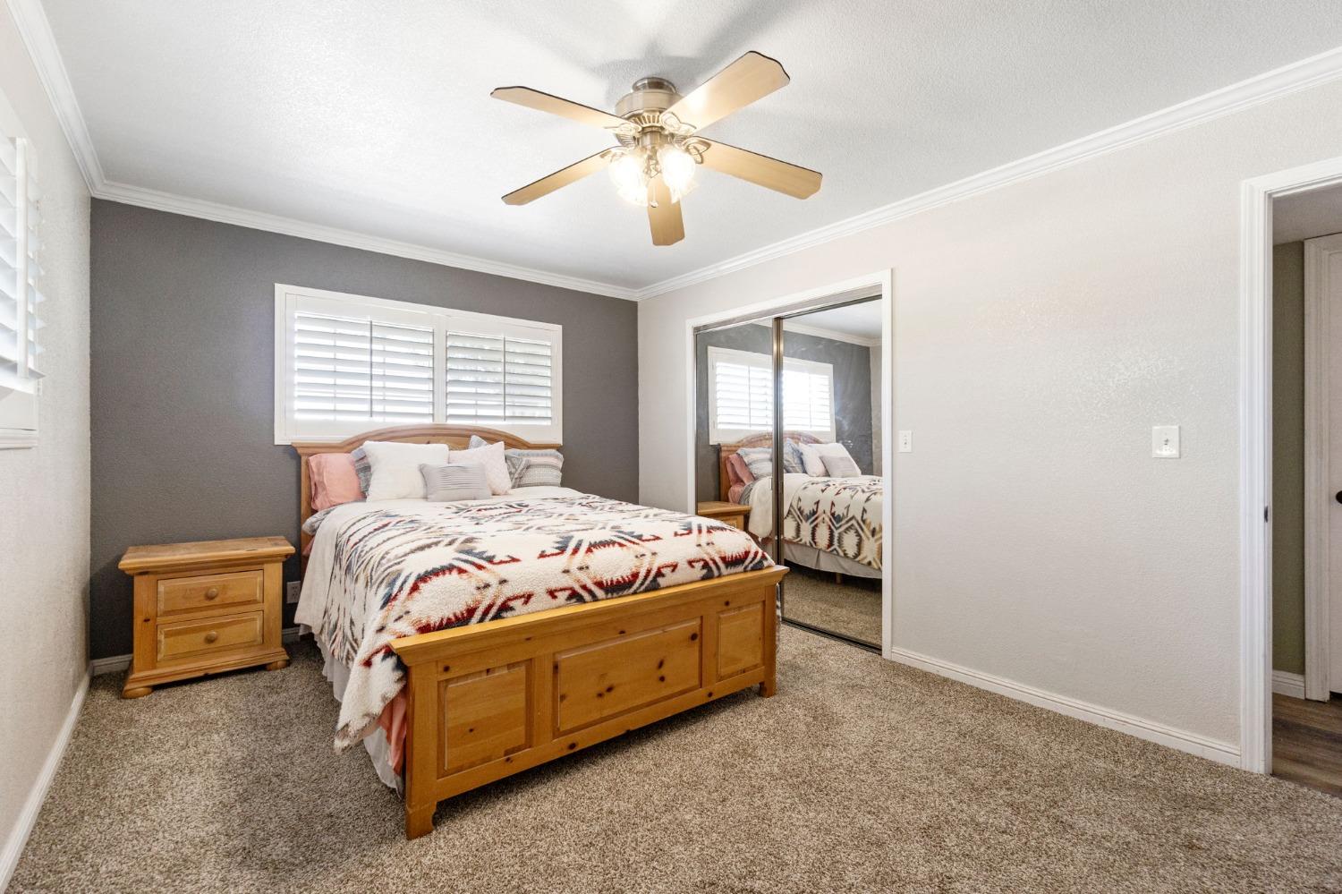 16972 Monreal Road Madera, CA 93636 - Photo 27 of 34 a bedroom with a bed and a chandelier