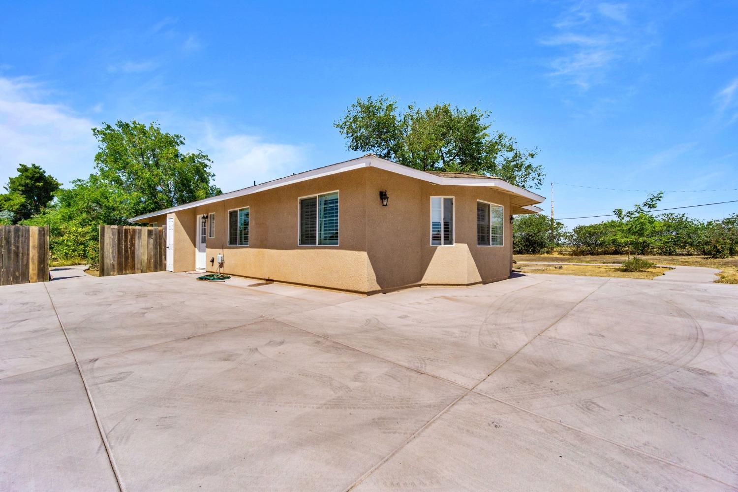 16972 Monreal Road Madera, CA 93636 - Photo 29 of 34 a front view of house with yard and trees around
