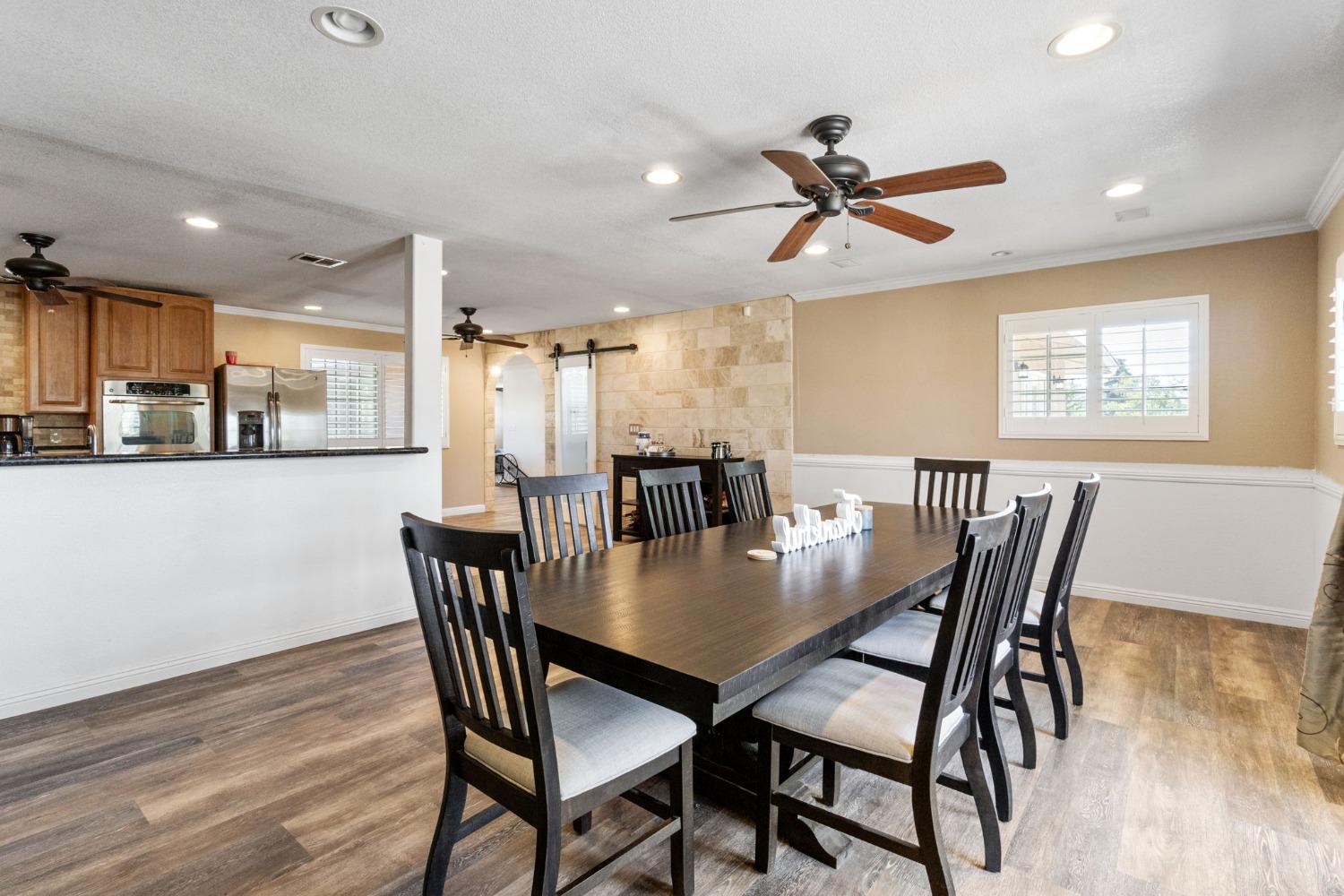 16972 Monreal Road Madera, CA 93636 - Photo 5 of 34 a view of a dining room with furniture and wooden floor