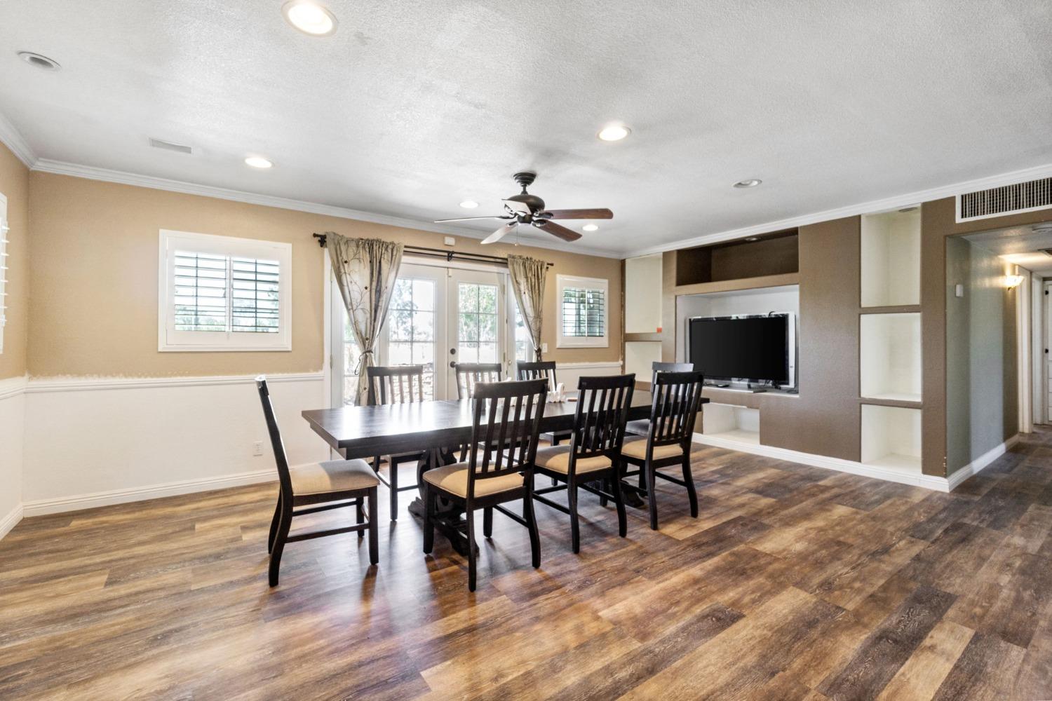 16972 Monreal Road Madera, CA 93636 - Photo 7 of 34 a view of a a dining room with furniture window and wooden floor