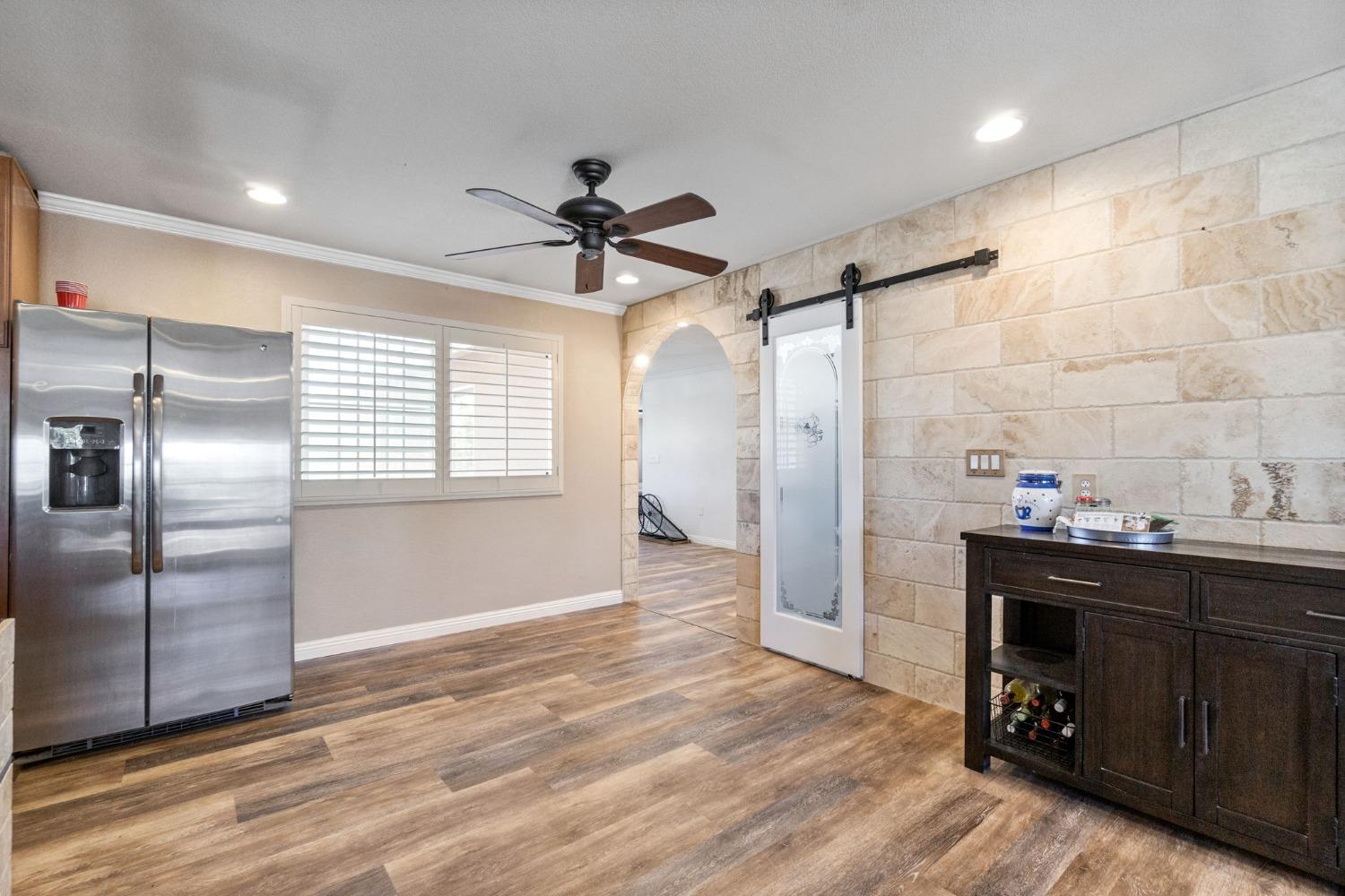 16972 Monreal Road Madera, CA 93636 - Photo 10 of 34 a view of a kitchen with a sink and a refrigerator