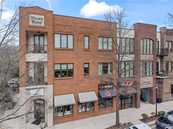 a front view of a brick building with many windows
