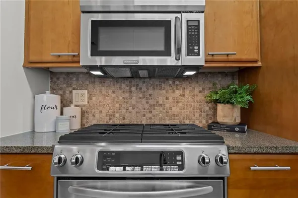 a stove top oven sitting inside of a kitchen
