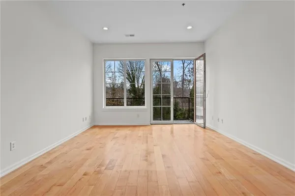 a view of a kitchen with wooden floor and a sink