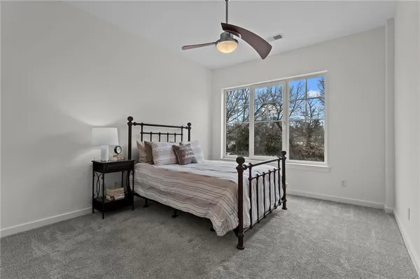a bedroom with a bed and window