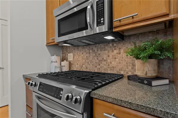 a stove top oven sitting inside of a kitchen