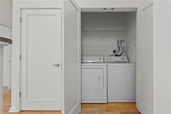 a view of a building with a garden and sitting area