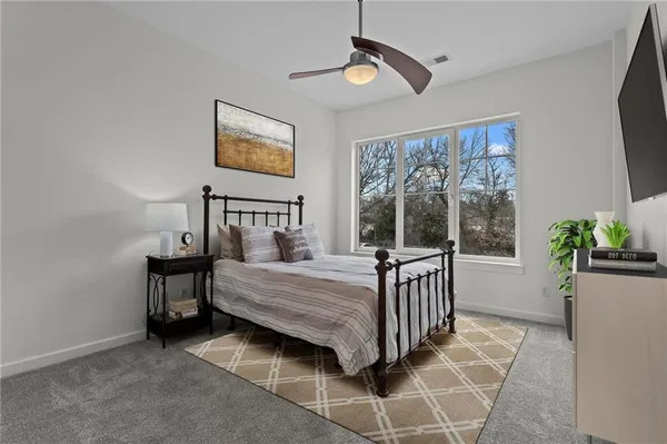 a bedroom with a bed next to a window with outer view