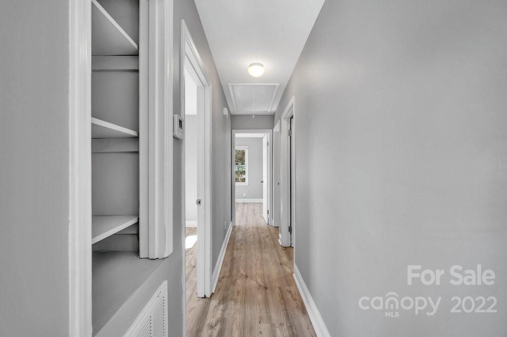 609 Unique Street Chester, SC 29706 - Photo 17 of 22 a view of a hallway with wooden floor and a bathroom