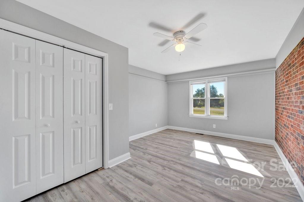 609 Unique Street Chester, SC 29706 - Photo 21 of 22 a view of an empty room with wooden floor and a window