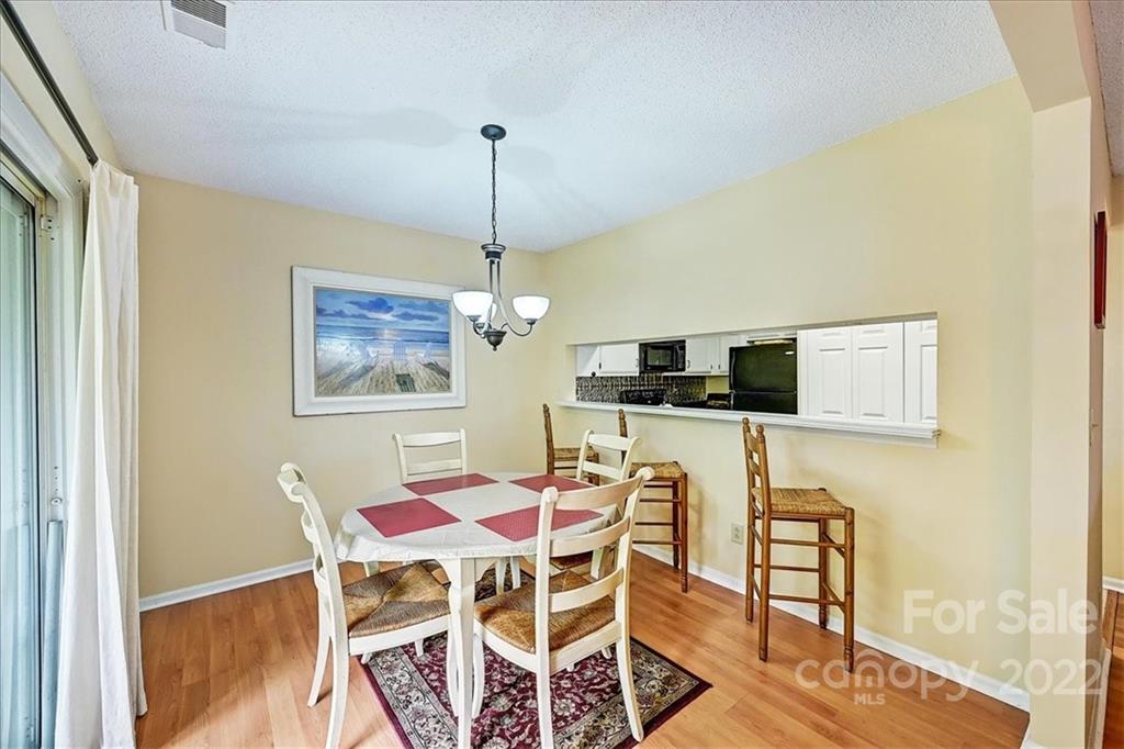 19843 Henderson Road, Unit B Cornelius, NC 28031 - Photo 11 of 43 a view of a dining room with furniture and wooden floor