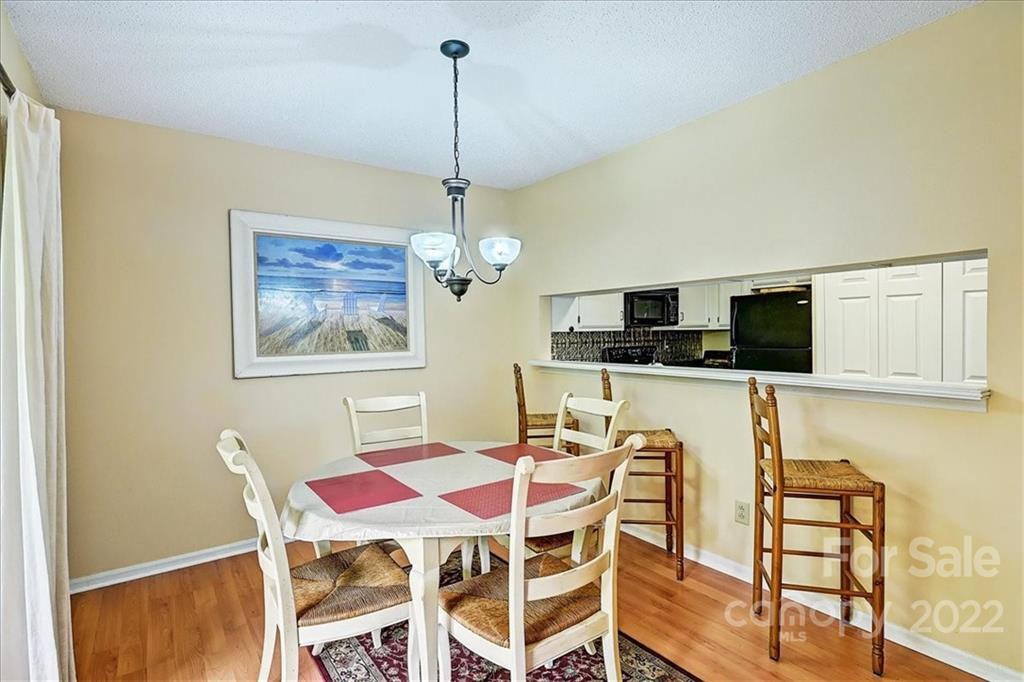 19843 Henderson Road, Unit B Cornelius, NC 28031 - Photo 12 of 43 a view of a dining room with furniture and wooden floor