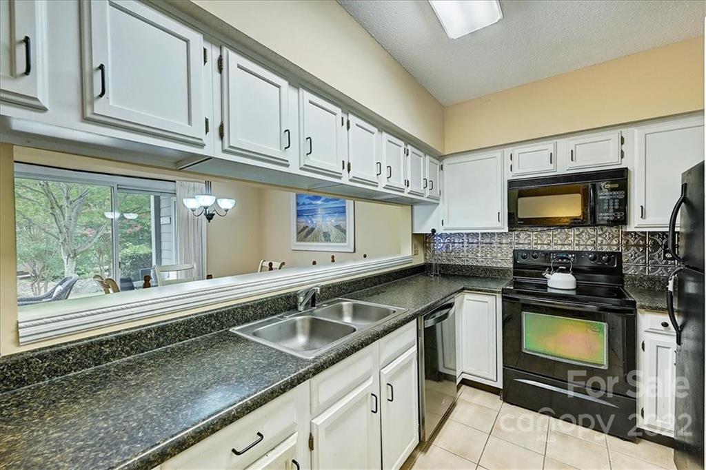 19843 Henderson Road, Unit B Cornelius, NC 28031 - Photo 18 of 43 a kitchen with stainless steel appliances granite countertop a sink a stove and cabinets