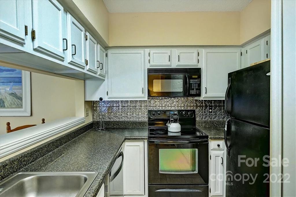 19843 Henderson Road, Unit B Cornelius, NC 28031 - Photo 19 of 43 a kitchen with a stove and a microwave