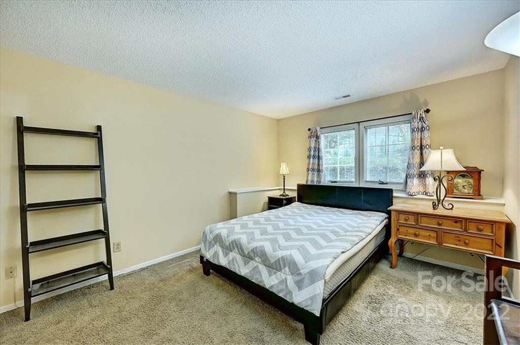 19843 Henderson Road, Unit B Cornelius, NC 28031 - Photo 20 of 43 a bedroom with a bed and a dresser
