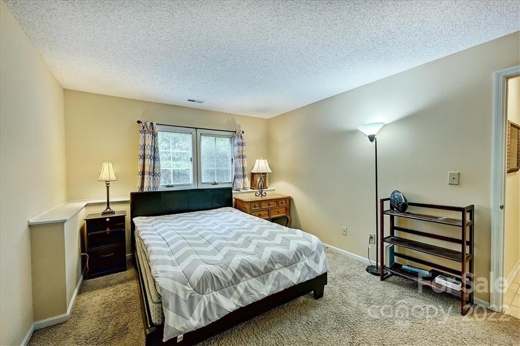 19843 Henderson Road, Unit B Cornelius, NC 28031 - Photo 21 of 43 a bedroom with a bed and wooden floor