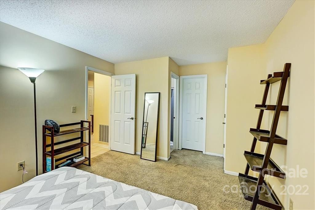 19843 Henderson Road, Unit B Cornelius, NC 28031 - Photo 22 of 43 a view of empty room with wooden floor and bathroom