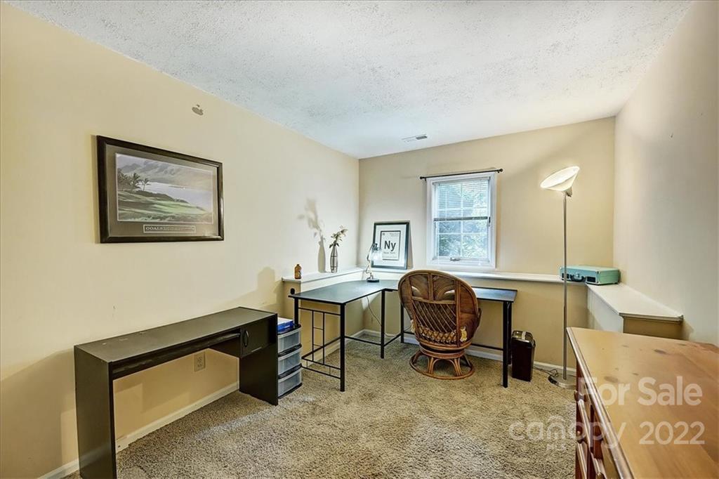 19843 Henderson Road, Unit B Cornelius, NC 28031 - Photo 24 of 43 a view of a workspace with furniture and a window
