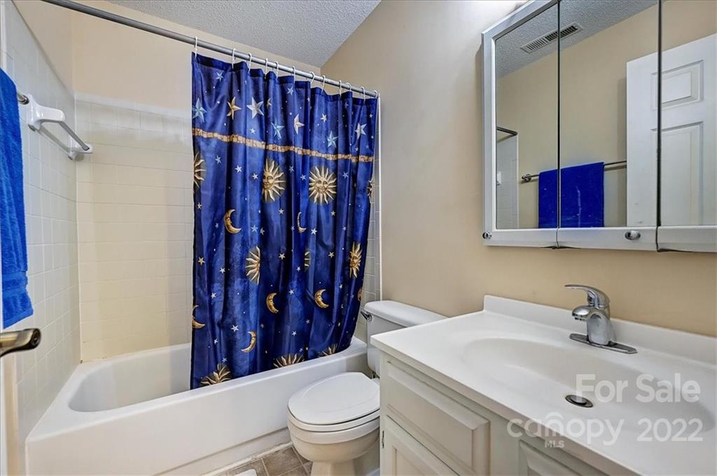 19843 Henderson Road, Unit B Cornelius, NC 28031 - Photo 26 of 43 a bathroom with a sink toilet vanity and shower