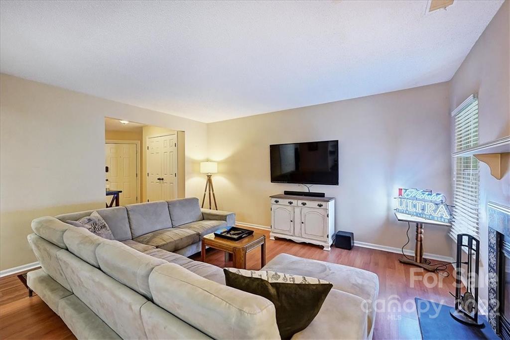 19843 Henderson Road, Unit B Cornelius, NC 28031 - Photo 10 of 43 a living room with furniture and a flat screen tv