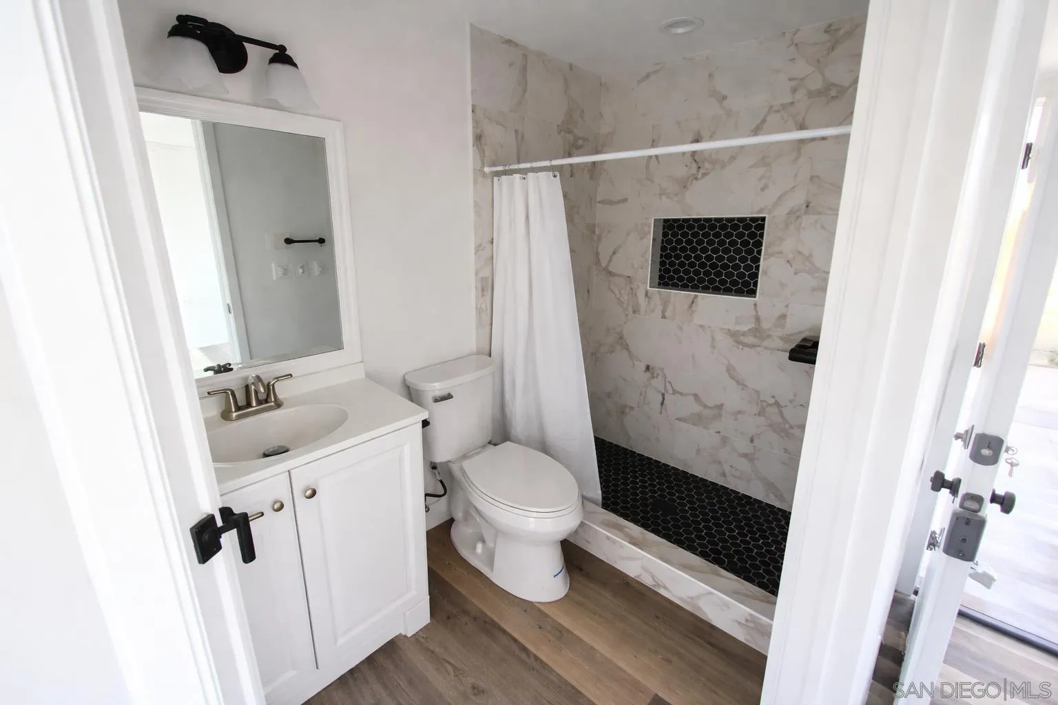 636 Aster Street Escondido, CA 92027 - Photo 4 of 8 a bathroom with a sink toilet and shower