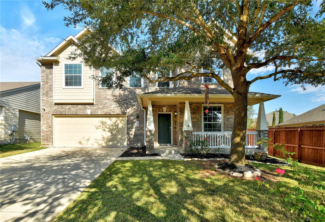 front view of a house with a tree in front