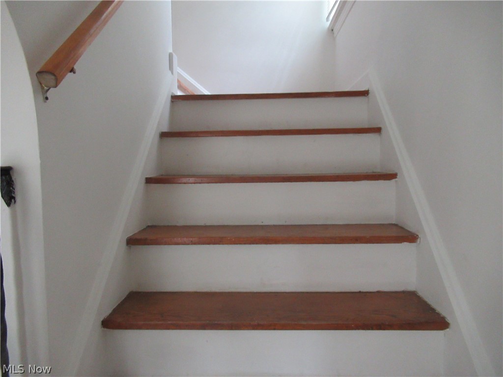 3824 East Antisdale Road Cleveland, OH 44118 - Photo 12 of 27 Staircase featuring wood-finish treads and risers, a wood-finish handrail, and painted white walls