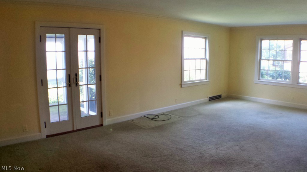 4567 Lake State Road Ashtabula, OH 44004 - Photo 3 of 25 Huge living room. French doors lead to a great screened porch
