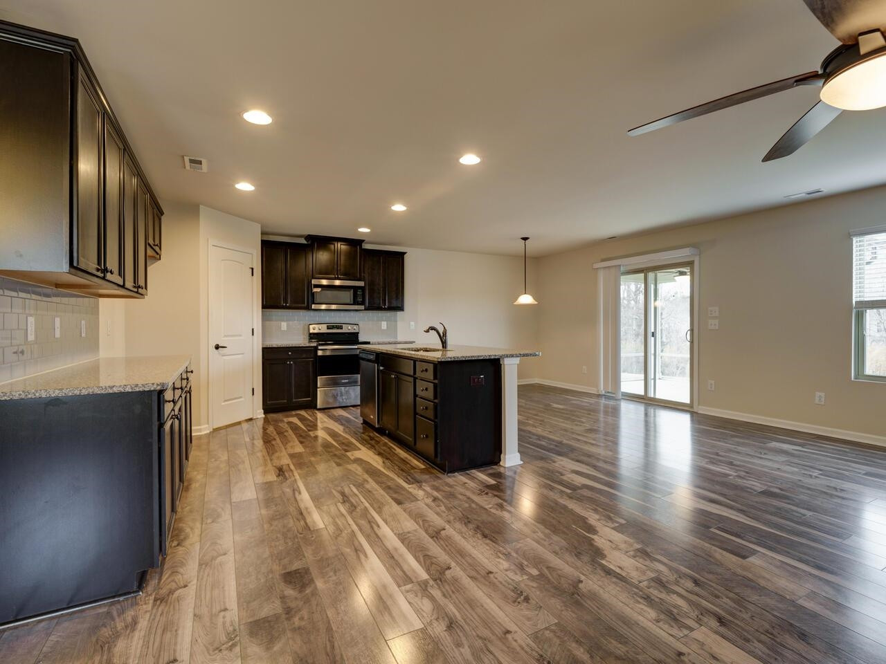 8167 Feldwig Place Raleigh, NC 27616 - Photo 8 of 51 Open and Bright. Granite Counters, SS Appliances, Walk in Pantry, Subway Tile Backsplash, Large Island, Tons of Cabinets and Counter Space. Kitchen
