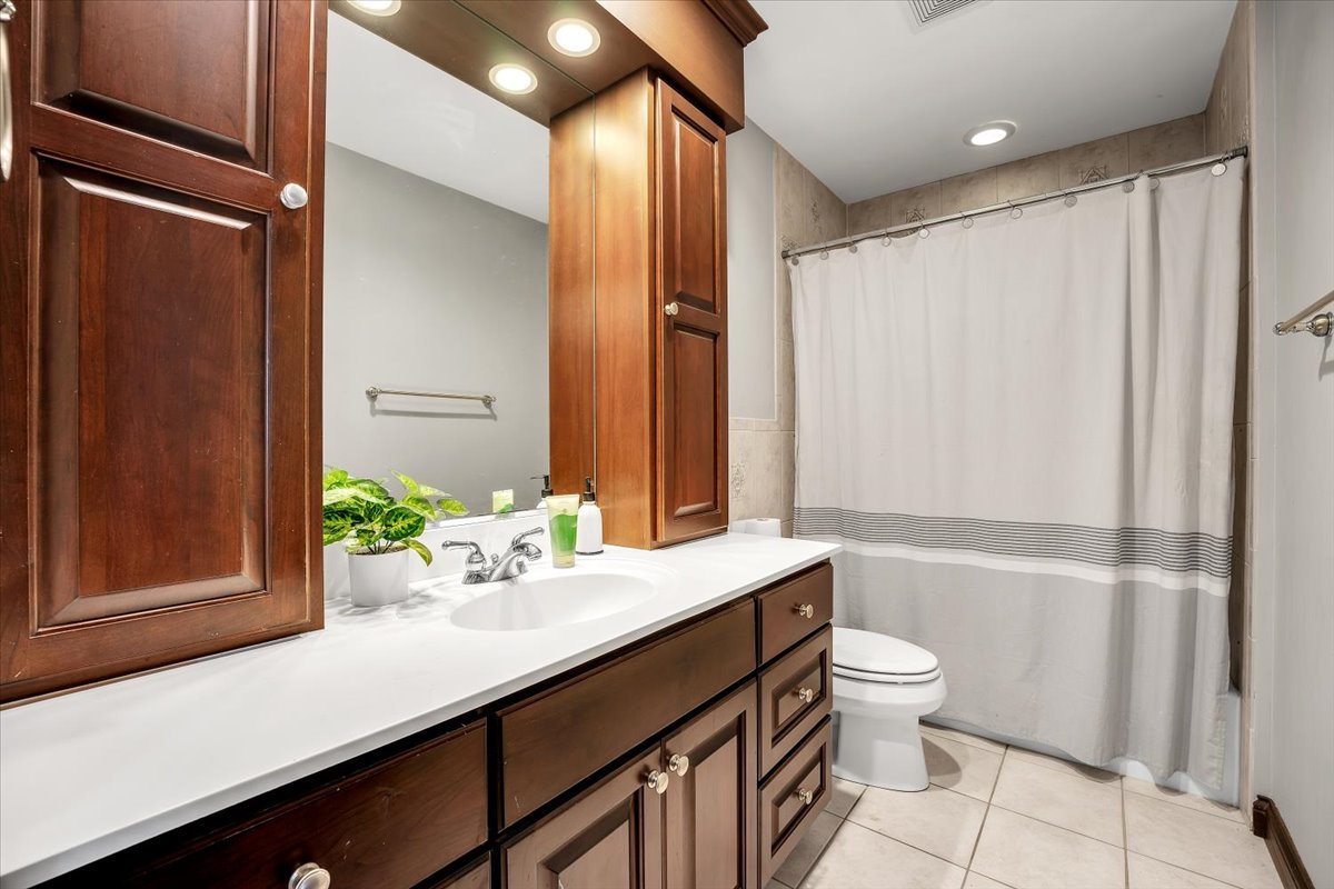 9N576 Crawford Road Elgin, IL 60124 - Photo 12 of 43 a bathroom with a sink a toilet and shower