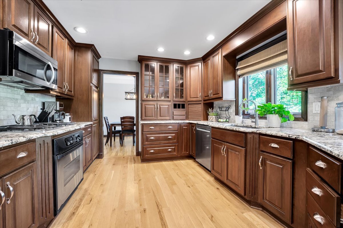 9N576 Crawford Road Elgin, IL 60124 - Photo 13 of 43 a large kitchen with stainless steel appliances granite countertop a stove a sink dishwasher and a refrigerator