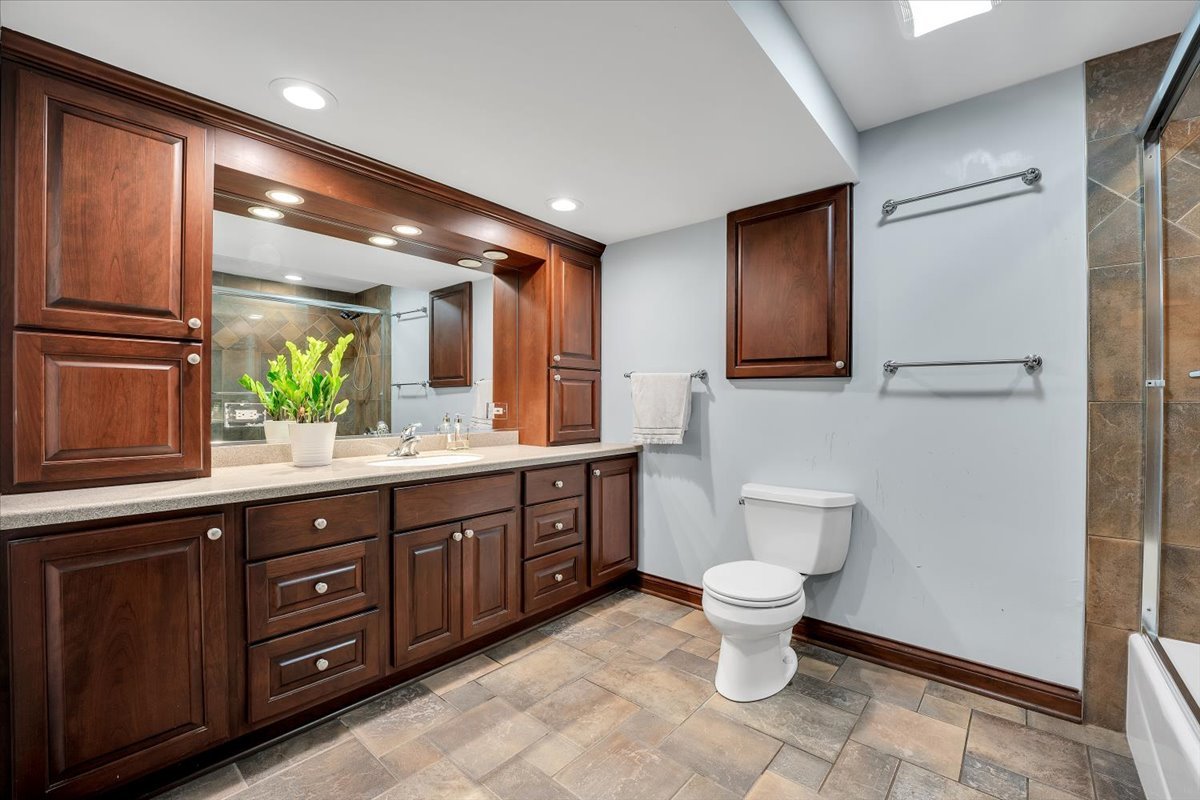 9N576 Crawford Road Elgin, IL 60124 - Photo 18 of 43 a bathroom with a double vanity sink toilet and a tub