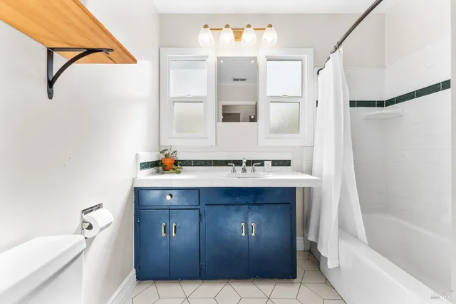 a bathroom with a tub sink and mirror