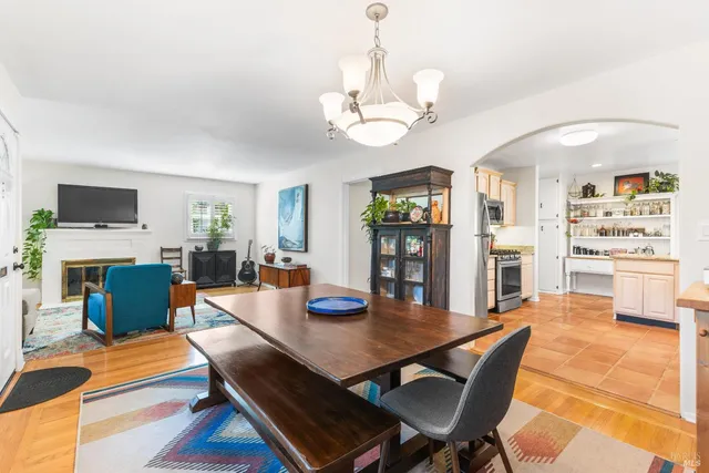 a view of a dining room with furniture a chandelier and wooden floor
