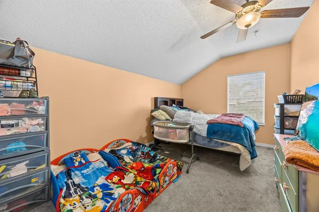 a bedroom with furniture and a baby crib