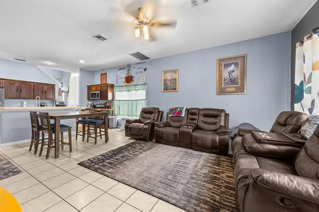 a living room with furniture kitchen view and a dining table