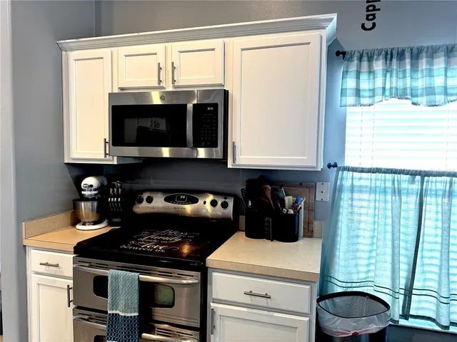 a kitchen with a stove and a microwave