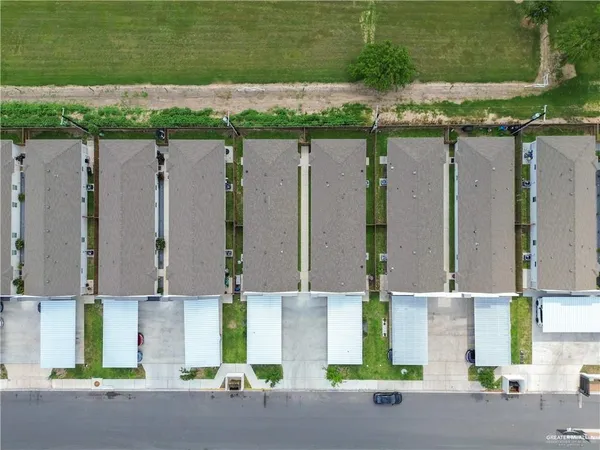 an aerial view of a house with a yard and garage